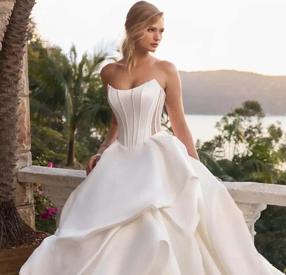 Model wearing a gown by Sophia Tolli